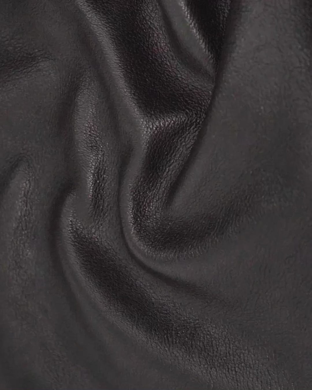 Video of Toulouse shrunken goat leather in ivory, gold cognac, olive, burgundy, chocolate and black, folded slowmotion